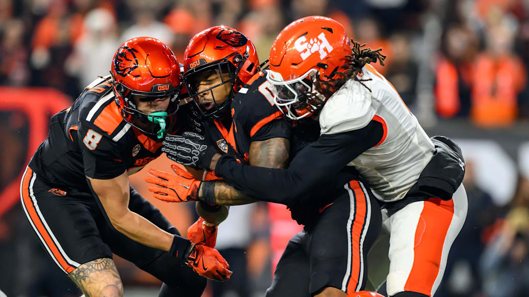 Nov 8, 2025; Corvallis, Oregon, USA; Sam Houston Bearkats defensive back Cecil Powell (2) stops Oregon State Beavers running back Anthony Hankerson (0) in the backfield for a loss during the second quarter at Reser Stadium. Mandatory Credit: Craig Strobeck-Imagn Images