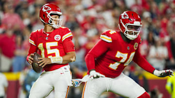 Oct 7, 2024; Kansas City, Missouri, USA; Kansas City Chiefs quarterback Patrick Mahomes (15) drops back to pass as offensive tackle Jawaan Taylor (74) gets ready to block during the first half against the New Orleans Saints at GEHA Field at Arrowhead Stadium. Mandatory Credit: Jay Biggerstaff-Imagn Images
