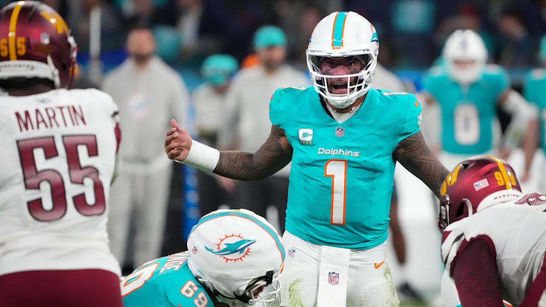 Miami Dolphins quarterback Tua Tagovailoa (1) calls a play at the line of scrimmage against the Washington Commanders in overtime during the 2025 NFL Madrid Game at Santiago Bernabeu Stadium. 