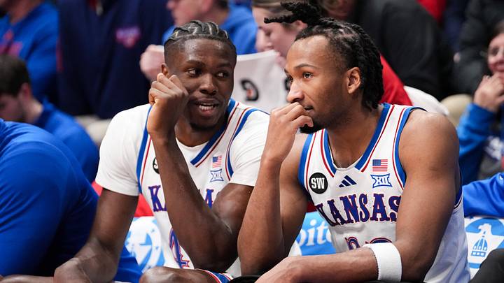 Jan 16, 2026; Lawrence, Kansas, USA; Kansas Jayhawks forward Flory Bidunga (40) and guard Darryn Peterson (22) talk on the bench against the Baylor Bears