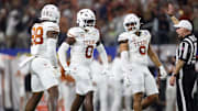 Jan 10, 2025; Arlington, Texas, USA; Texas Longhorns linebacker Anthony Hill Jr. (0) celebrates with linebacker Barryn Sorrell (88) and linebacker Trey Moore (8) after a play during the second quarter of the College Football Playoff semifinal against the Ohio State Buckeyes in the Cotton Bowl at AT&T Stadium. Mandatory Credit: Tim Heitman-Imagn Images
