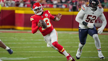 Aug 22, 2024; Kansas City, Missouri, USA; Kansas City Chiefs quarterback Chris Oladokun (13) scrambles as Chicago Bears defensive end Khalid Kareem (52) chases during the first half at GEHA Field at Arrowhead Stadium. Mandatory Credit: Denny Medley-Imagn Images