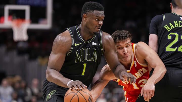 Mar 10, 2024; Atlanta, Georgia, USA; New Orleans Pelicans forward Zion Williamson (1) dribbles against Atlanta Hawks guard Bogdan Bogdanovic (13) during the second half at State Farm Arena.