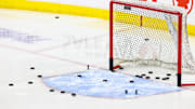 Nov 3, 2024; Calgary, Alberta, CAN; General view of the net with pucks during the warmup period between the Calgary Flames and the Edmonton Oilers at Scotiabank Saddledome. Mandatory Credit: Sergei Belski-Imagn Images