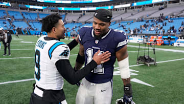 Dec 15, 2024; Charlotte, North Carolina, USA;  Carolina Panthers quarterback Bryce Young (9) with Dallas Cowboys linebacker Micah Parsons (11) after the game at Bank of America Stadium. Mandatory Credit: Bob Donnan-Imagn Images