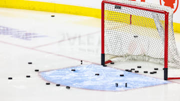 Nov 3, 2024; Calgary, Alberta, CAN; General view of the net with pucks during the warmup period between the Calgary Flames and the Edmonton Oilers at Scotiabank Saddledome. Mandatory Credit: Sergei Belski-Imagn Images