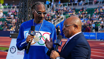 Snoop Dogg (left) talks with NBC Sports broadcaster Mike Tirico during the US Olympic Team Trials at Hayward Field on June 23, 2024.