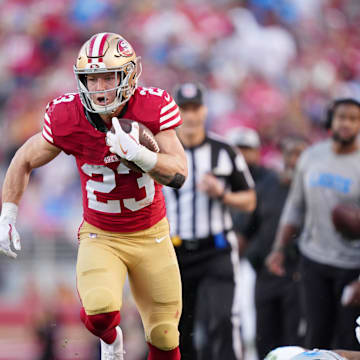 Jan 28, 2024; Santa Clara, California, USA; San Francisco 49ers running back Christian McCaffrey (23) runs with the ball against Detroit Lions safety C.J. Gardner-Johnson (2) during the first half of the NFC Championship football game at Levi's Stadium. Mandatory Credit: Kyle Terada-Imagn Images