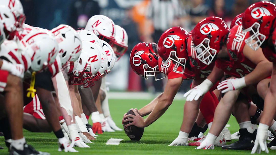 Helmets at the line of scrimmage as Utah Utes long snapper Logan Castor snaps the ball against the Nebraska Cornhuskers in the first half during the SRS Distribution Las Vegas Bowl at Allegiant Stadium.