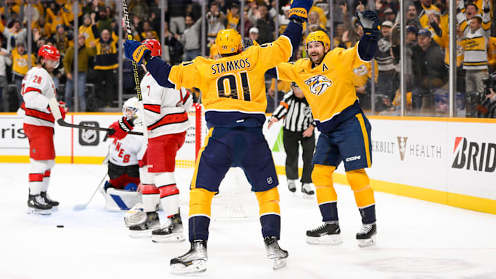 Dec 23, 2024; Nashville, Tennessee, USA;  Nashville Predators center Steven Stamkos (91) celebrates his goal with left wing Filip Forsberg (9) against the Carolina Hurricanes during the first period at Bridgestone Arena. Mandatory Credit: Steve Roberts-Imagn Images