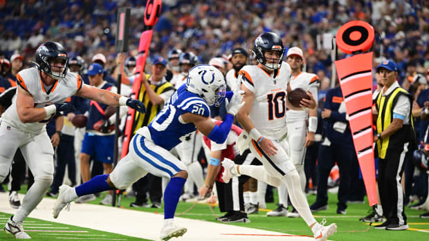 Aug 11, 2024; Indianapolis, Indiana, USA;  Denver Broncos quarterback Bo Nix (10) is pushed out of bounds by Indianapolis Col