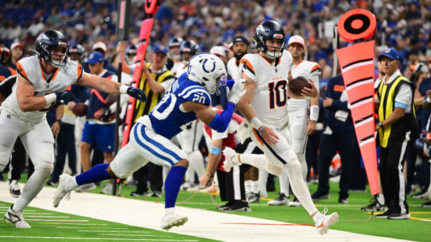 Denver Broncos quarterback Bo Nix (10) is pushed out of bounds by Indianapolis Colts safety Nick Cross