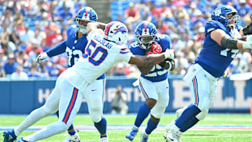 Aug 9, 2025; Orchard Park, New York, USA; Buffalo Bills defensive end Greg Rousseau (50) tackles New York Giants running back Tyrone Tracy Jr. (29) in the first quarter at Highmark Stadium. Mandatory Credit: Mark Konezny-Imagn Images