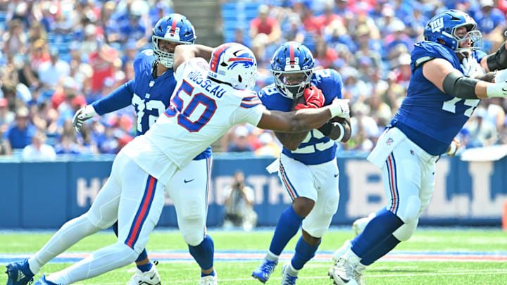 Aug 9, 2025; Orchard Park, New York, USA; Buffalo Bills defensive end Greg Rousseau (50) tackles New York Giants running back Tyrone Tracy Jr. (29) in the first quarter at Highmark Stadium. Mandatory Credit: Mark Konezny-Imagn Images