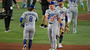 Oct 25, 2025; Toronto, Ontario, CAN; Los Angeles Dodgers second baseman Tommy Edman (25) and first baseman Enrique Hernandez (8) celebrate after the win against the Toronto Blue Jays in game two of the 2025 MLB World Series at Rogers Centre. Mandatory Credit: Nick Turchiaro-Imagn Images