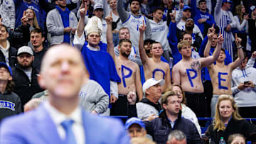 Dec 14, 2024; Lexington, Kentucky, USA; Kentucky Wildcats fans stand with the letters POPE painted on their stomachs after the game against the Louisville Cardinals at Rupp Arena at Central Bank Center. Mandatory Credit: Jordan Prather-Imagn Images