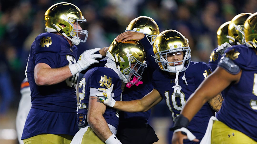 Notre Dame running back Aneyas Williams, second from left, celebrates with teammates after scoring a touchdown in the second half of a NCAA football game against Syracuse at Notre Dame Stadium on Saturday, Nov. 22, 2025, in South Bend.