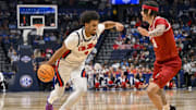 Mar 13, 2025; Nashville, TN, USA;  Mississippi Rebels forward Jaemyn Brakefield (4) drives to the basket as Arkansas Razorbacks forward Trevon Brazile (4) defends during the first half at Bridgestone Arena. Mandatory Credit: Steve Roberts-Imagn Images