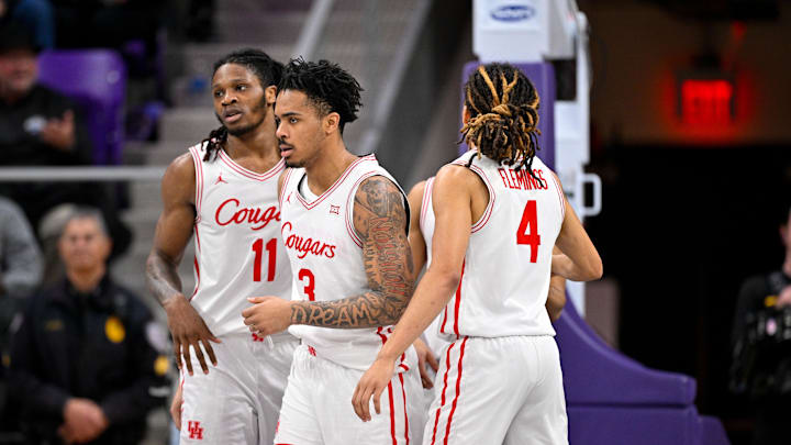 Houston Cougars forward Joseph Tugler (11) and guard Ramon Walker Jr. (3) and guard Kingston Flemings (4) 