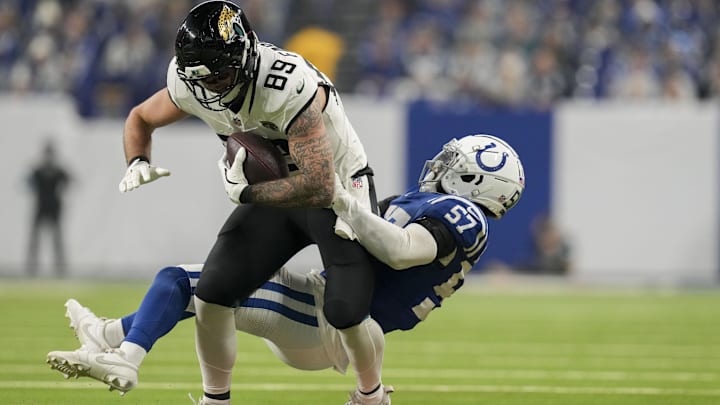 Jan 5, 2025; Indianapolis, Indiana, USA; Indianapolis Colts linebacker Jaylon Carlies (57) works to bring down Jacksonville Jaguars tight end Luke Farrell (89) during a game against the Jacksonville Jaguars at Lucas Oil Stadium. Mandatory Credit: Christine Tannous-USA TODAY Network via Imagn Images Jan 5, 2025; Indianapolis, Indiana, USA; Indianapolis Colts linebacker Jaylon Carlies (57) works to bring down Jacksonville Jaguars tight end Luke Farrell (89) during a game against the Jacksonville Jaguars at Lucas Oil Stadium. Mandatory Credit: Christine Tannous-USA TODAY Network via Imagn Images