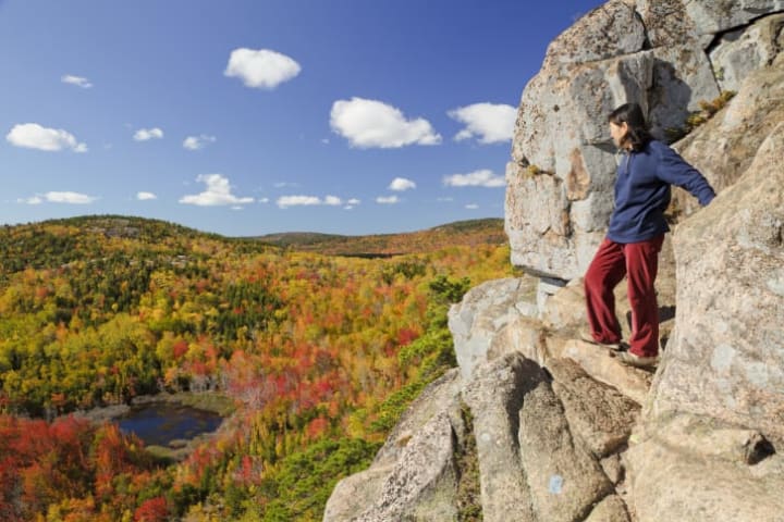 An intrepid climber on a cliff off the Beehive Mountain in Acadia National Park.
