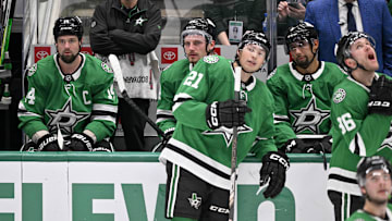 Apr 12, 2025; Dallas, Texas, USA; Dallas Stars left wing Jamie Benn (14) and center Roope Hintz (24) and left wing Jason Robertson (21) and defenseman Matt Dumba (3) and right wing Mikko Rantanen (96) look on as Benn’s goal against the Utah Hockey Club is under review during the third period at the American Airlines Center. Mandatory Credit: Jerome Miron-Imagn Images