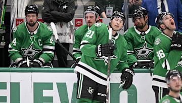 Apr 12, 2025; Dallas, Texas, USA; Dallas Stars left wing Jamie Benn (14) and center Roope Hintz (24) and left wing Jason Robertson (21) and defenseman Matt Dumba (3) and right wing Mikko Rantanen (96) look on as Benn’s goal against the Utah Hockey Club is under review during the third period at the American Airlines Center. Mandatory Credit: Jerome Miron-Imagn Images