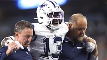 Dallas Cowboys linebacker DeMarvion Overshown (13) is helped off the field after an injury in the second half against the Cincinnati Bengals at AT&T Stadium.