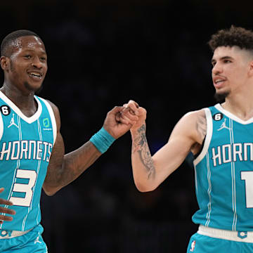 Dec 23, 2022; Los Angeles, California, USA; Charlotte Hornets guard Terry Rozier (3) celebrates with guard LaMelo Ball (1) after a three-point basket in the second half against the Los Angeles Lakers at Crypto.com Arena. The Hornets defeated the Lakers 134-130. Mandatory Credit: Kirby Lee-Imagn Images