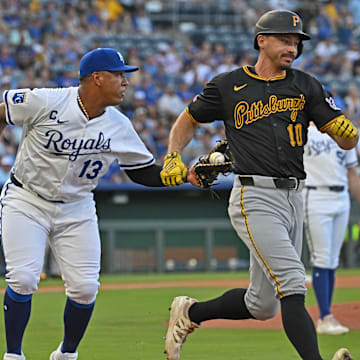 Jul 9, 2025; Kansas City, Missouri, USA;  Kansas City Royals first baseman Salvador Perez (13) tags out Pittsburgh Pirates right fielder Bryan Reynolds (10) running up the first base line in the first inning at Kauffman Stadium. Mandatory Credit: Peter Aiken-Imagn Images