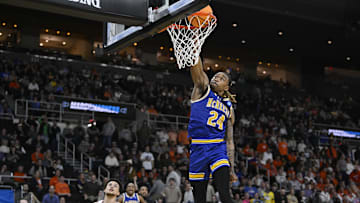 Mar 20, 2025; Providence, RI, USA; McNeese State Cowboys forward Christian Shumate (24) dunks against Clemson Tigers guard Chase Hunter (1) during the second half at Amica Mutual Pavilion. Mandatory Credit: Eric Canha-Imagn Images