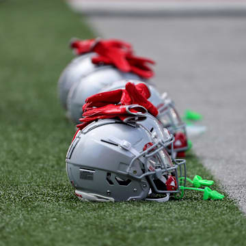 Aug 31, 2024; Columbus, Ohio, USA;  Ohio State Buckeyes helmets on the field before a game against the Akron Zips at Ohio Stadium. Mandatory Credit: Joseph Maiorana-Imagn Images