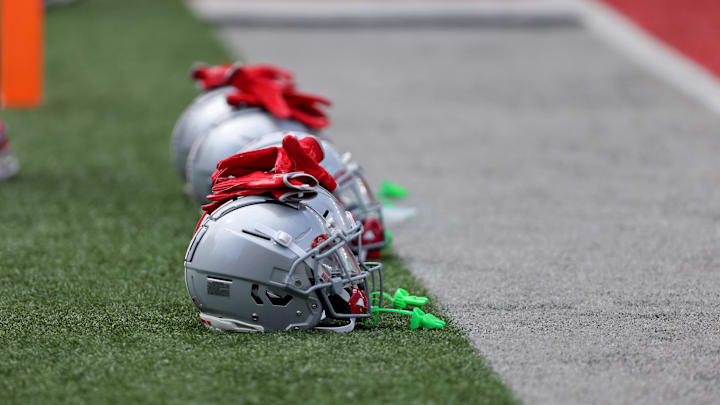 Aug 31, 2024; Columbus, Ohio, USA;  Ohio State Buckeyes helmets on the field before a game against the Akron Zips at Ohio Stadium. Mandatory Credit: Joseph Maiorana-Imagn Images