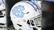 Dec 27, 2023; Charlotte, NC, USA; North Carolina Tar Heels white helmet during pregame warm ups against the West Virginia Mountaineers at Bank of America Stadium. Mandatory Credit: Jim Dedmon-Imagn Images
