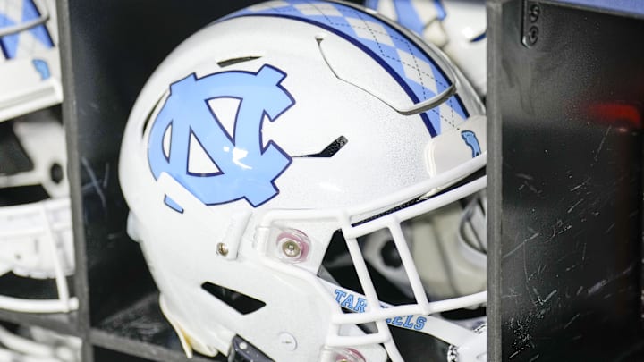 Dec 27, 2023; Charlotte, NC, USA; North Carolina Tar Heels white helmet during pregame warm ups against the West Virginia Mountaineers at Bank of America Stadium. Mandatory Credit: Jim Dedmon-Imagn Images Dec 27, 2023; Charlotte, NC, USA; North Carolina Tar Heels white helmet during pregame warm ups against the West Virginia Mountaineers at Bank of America Stadium. Mandatory Credit: Jim Dedmon-Imagn Images