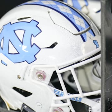Dec 27, 2023; Charlotte, NC, USA; North Carolina Tar Heels white helmet during pregame warm ups against the West Virginia Mountaineers at Bank of America Stadium. Mandatory Credit: Jim Dedmon-Imagn Images