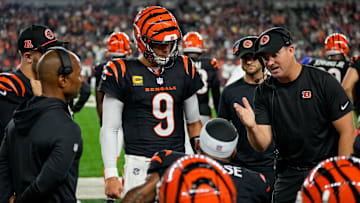 Cincinnati Bengals quarterback Joe Burrow (9) and head coach Zac Taylor talk with wide receiver Ja'Marr Chase (1) on the bench after a drive in the fourth quarter of the NFL Week 3 game between the Cincinnati Bengals and the Washington Commanders at Paycor Stadium in downtown Cincinnati on Monday, Sept. 23, 2024. The Bengals remain winless after a 38-33 loss to Washington.