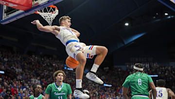 Nov 11, 2025; Lawrence, Kansas, USA; Kansas Jayhawks guard Kohl Rosario (7) dunks the ball during the first half against the Texas A&M-Corpus Christi Islanders at Allen Fieldhouse. Mandatory Credit: Jay Biggerstaff-Imagn Images