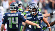 Nov 9, 2025; Seattle, Washington, USA;  Seattle Seahawks wide receiver Jaxon Smith-Njigba (11) celebrates with Seattle Seahawks quarterback Sam Darnold (14) after scoring a touchdown during the first quarter against the Arizona Cardinals at Lumen Field. Mandatory Credit: Steven Bisig-Imagn Images