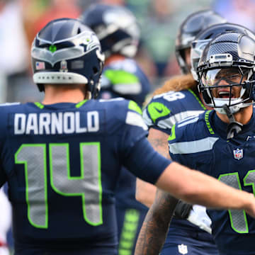 Nov 9, 2025; Seattle, Washington, USA;  Seattle Seahawks wide receiver Jaxon Smith-Njigba (11) celebrates with Seattle Seahawks quarterback Sam Darnold (14) after scoring a touchdown during the first quarter against the Arizona Cardinals at Lumen Field. Mandatory Credit: Steven Bisig-Imagn Images