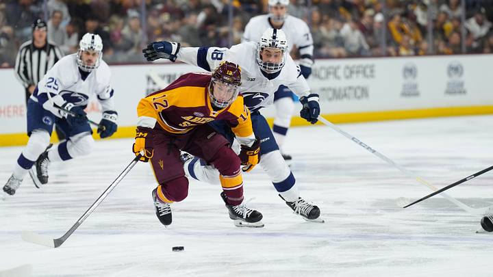 Oct 3, 2025; Tempe, AZ, USA; Arizona State forward Cullen Potter (12) and Penn State Nittany Lionsforward Aiden Fink (18) chase a puck during the first period at Mullett Arena. Mandatory Credit: Joe Camporeale-Imagn Images