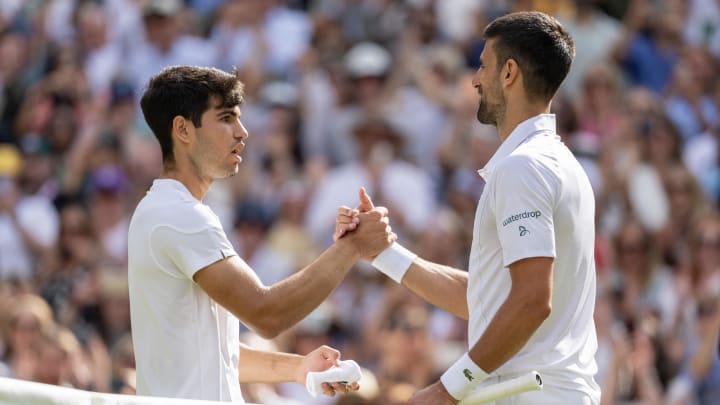 Jul 14, 2024; London, United Kingdom; Carlos Alcaraz of Spain and Novak Djokovic of Serbia at the net after the men’s singles final on day 14 at All England Lawn Tennis and Croquet Club. Mandatory Credit: Susan Mullane-USA TODAY Sports