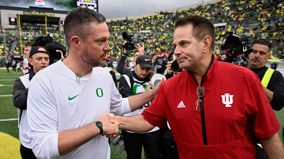Oregon Ducks head coach Dan Lanning shakes hands with Indiana Hoosiers head coach Curt Cignetti after a game.