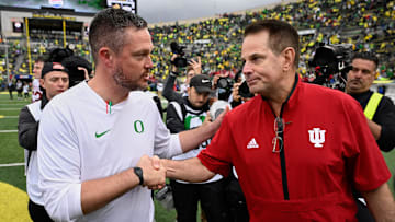 Oct 11, 2025; Eugene, Oregon, USA; Oregon Ducks head coach Dan Lanning shakes hands with Indiana Hoosiers head coach Curt Cignetti after Indiana defeated Oregon by the score of 30-20 at Autzen Stadium. Mandatory Credit: Troy Wayrynen-Imagn Images