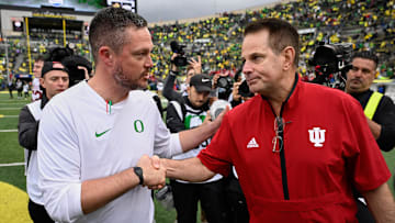 Oct 11, 2025; Eugene, Oregon, USA; Oregon Ducks head coach Dan Lanning shakes hands with Indiana Hoosiers head coach Curt Cignetti after Indiana defeated Oregon by the score of 30-20 at Autzen Stadium. Mandatory Credit: Troy Wayrynen-Imagn Images