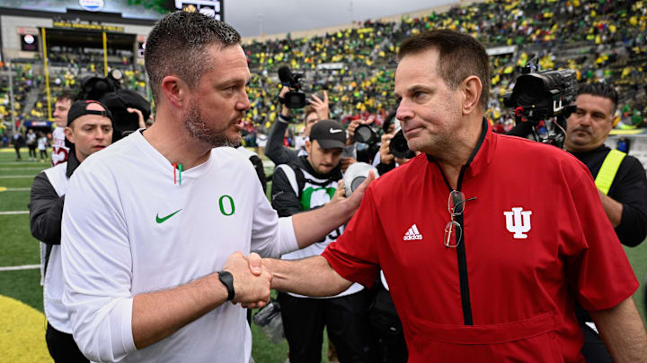 Oct 11, 2025; Eugene, Oregon, USA; Oregon Ducks head coach Dan Lanning shakes hands with Indiana Hoosiers head coach Curt Cignetti after Indiana defeated Oregon by the score of 30-20 at Autzen Stadium. Mandatory Credit: Troy Wayrynen-Imagn Images
