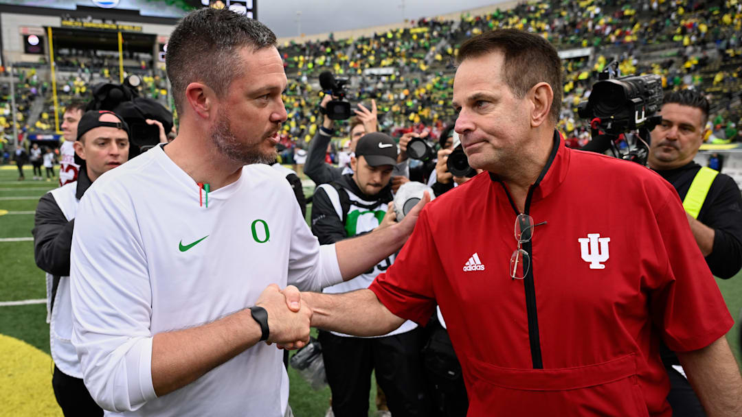 Oregon Ducks head coach Dan Lanning shakes hands with Indiana Hoosiers head coach Curt Cignetti