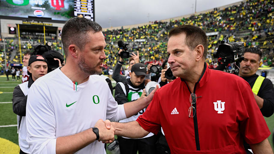 Oregon Ducks head coach Dan Lanning shakes hands with Indiana Hoosiers head coach Curt Cignetti