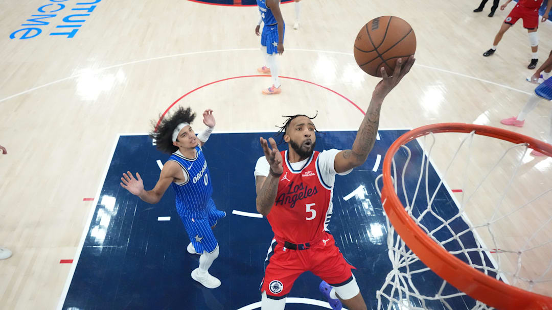 Feb 22, 2026; Inglewood, California, USA; LA Clippers forward Derrick Jones Jr. (5) shoots the ball against Orlando Magic guard Anthony Black (0) in the second half at Intuit Dome. Mandatory Credit: Kirby Lee-Imagn Images