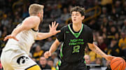 Nov 7, 2023; Iowa City, Iowa, USA; North Dakota Fighting Hawks guard Treysen Eaglestaff (52) dribbles against Iowa Hawkeyes forward Ben Krikke (23) during the first half at Carver-Hawkeye Arena. Mandatory Credit: Jeffrey Becker-Imagn Images